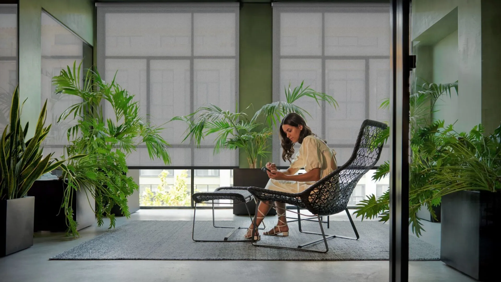 A woman configuring window solutions on a tablet